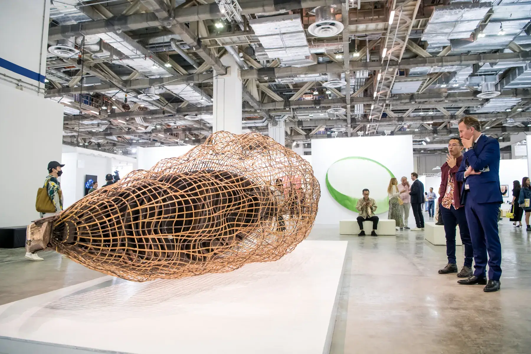 Visitors observe a large woven contemporary sculpture at ART SG 2023, an international art fair showcasing leading regional and global galleries — a vibrant setting that reflects the artistic dialogue embraced by Phan Ling Gallery.